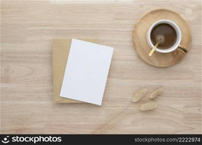Blank paper cards, Blank greeting card invitation Mockup with Dried Bunny Tail grass and coffee cup on wood table, wood desk background, Minimal wood table workplace composition, flat lay, mockup