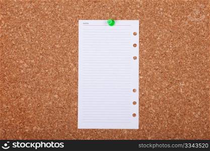 Blank paper note on a corkboard.