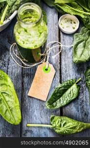 blank paper notes sign on green healthy Spinach smoothie in bottle on blue rustic wooden backgroundNY DSC