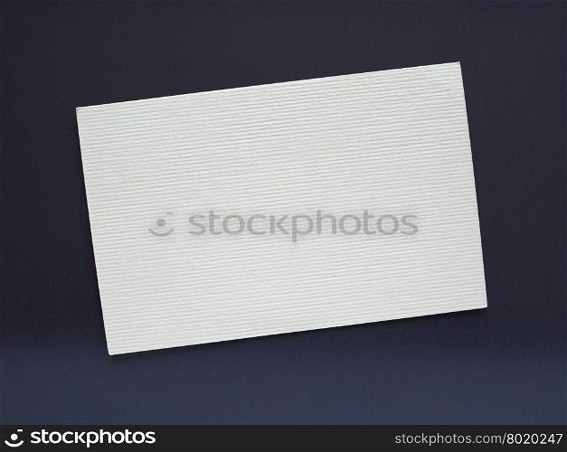 Blank paper tag label. Blank paper tag label or sticker with copy space - flat lay on black desktop background