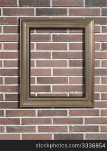 Blank photo frame on old brick wall.