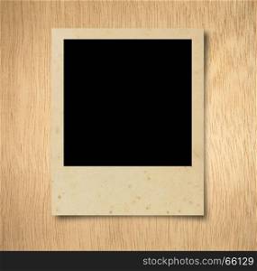 Blank photo frame on wood background