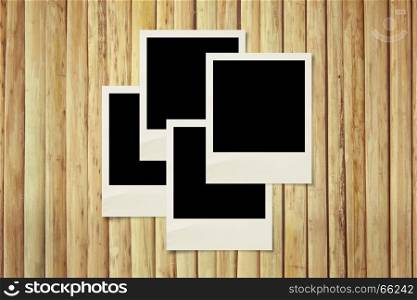 Blank photos frames on wood background