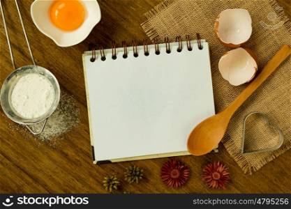 Blank recipe notebook for text on wood background