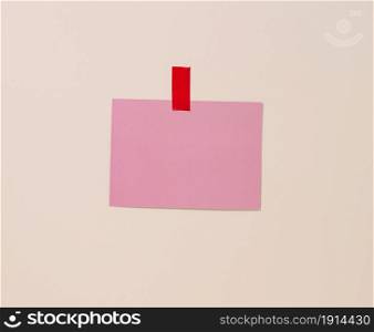 blank rectangular pink sheet of paper glued on a light blue background. Place for an inscription, announcement