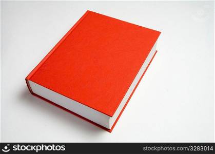 Blank red book on white.