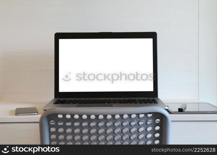 blank screen laptop computer with table lamp is on twooden desk as workplace concept