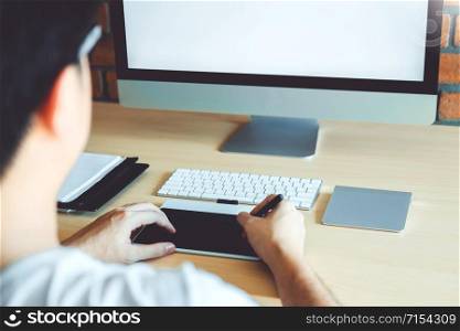 Blank screen of Graphic designer drawing on graphics tablet at workplace