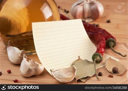 blank sheet for cooking recipes and spices on a wooden table