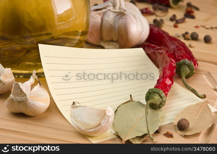 blank sheet for cooking recipes and spices on a wooden table