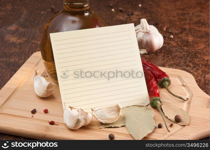 blank sheet for cooking recipes and spices on a wooden table