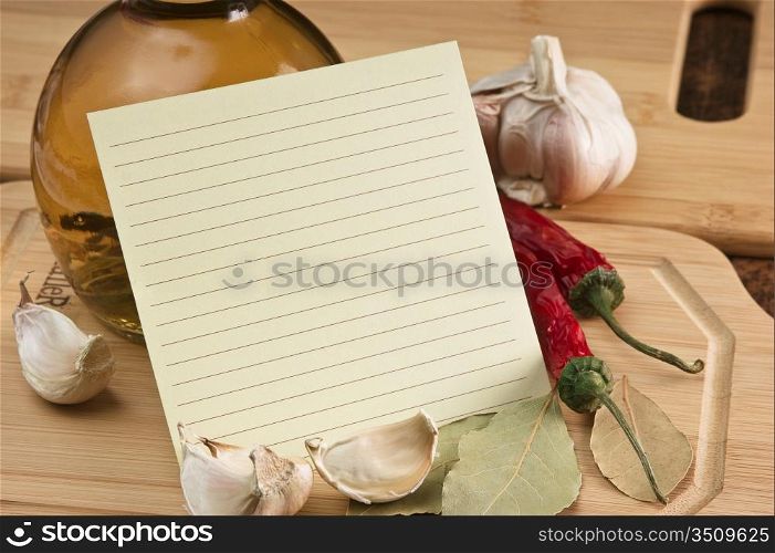 blank sheet for cooking recipes and spices on a wooden table