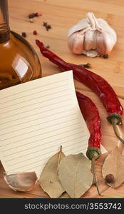 blank sheet for cooking recipes and spices on a wooden table