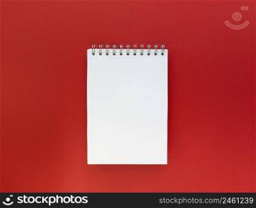 Blank sheet of notebook red background. Educational concept. Flat lay with copy space. Stock photography.. Blank sheet of notebook red background. Educational concept. Flat lay with copy space. Stock photo.