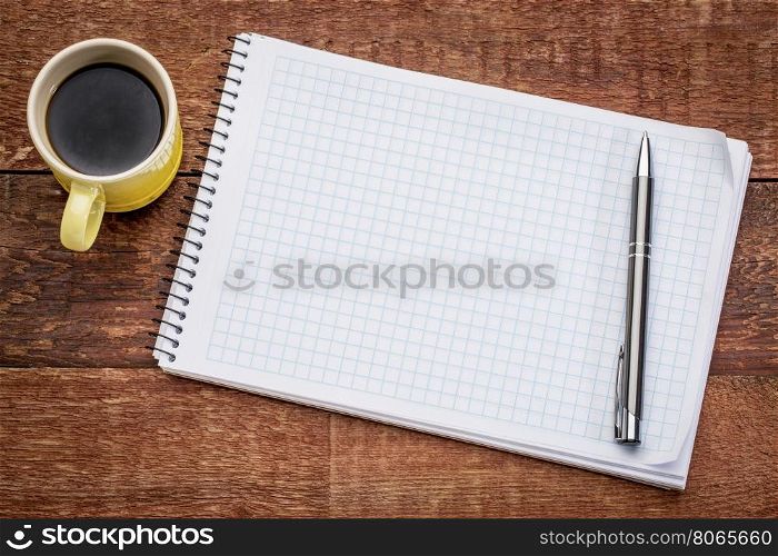 blank spiral notebook, and a cup of coffee against rustic wood