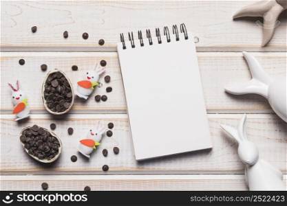 blank spiral notepad easter eggs with choco chips bunnies wooden backdrop