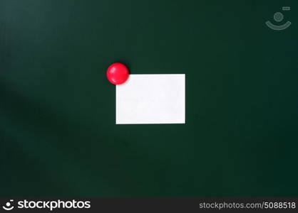 Blank stick note on a green board with copy space