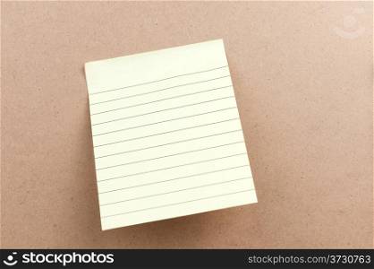 Blank sticky note attached on the wooden board