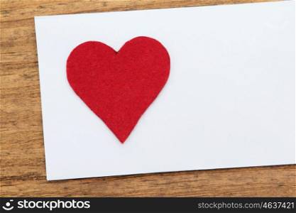 Blank sticky note with a red heart