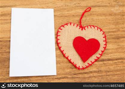 Blank sticky note with a red heart