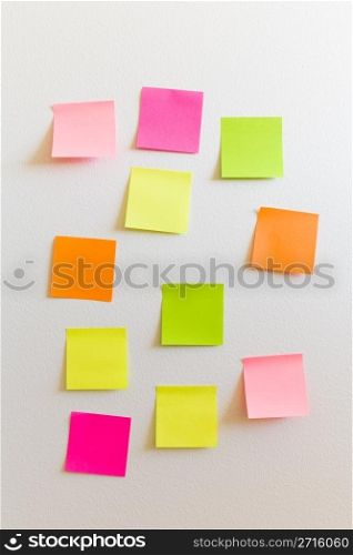 Blank sticky notes attached to a white wall.