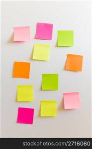 Blank sticky notes attached to a white wall.