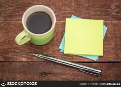 blank sticky notes, pen and espresso coffee on a rust barn wood table