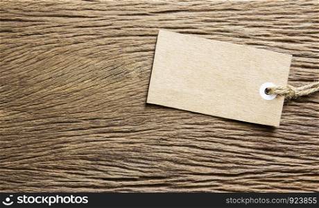 Blank tag tied on wooden background
