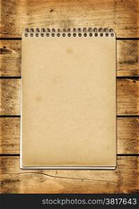 Blank vintage notebook on a wood board panel. Blank vintage notebook on a wood board