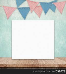 Blank white board and party flags hanging on green cement wall background, copy space for text