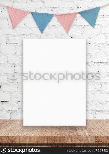 Blank white board and party flags hanging on white brick wall background, copy space for text