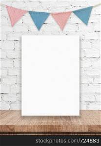 Blank white board and party flags hanging on white brick wall background, copy space for text