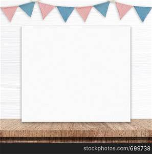 Blank white board and party flags hanging on white wood wall background, copy space for text