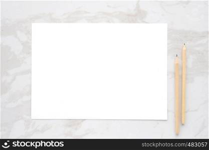 Blank white note paper and pencils on white marble background, flat lay, top view, template