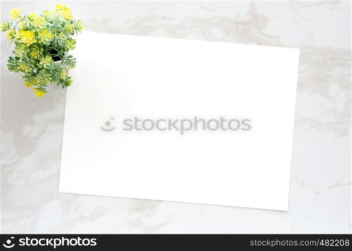 Blank white note paper on white marble background, flat lay, top view, template