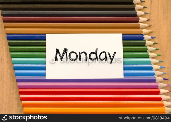 Blank white paper and colored pencils on wooden background