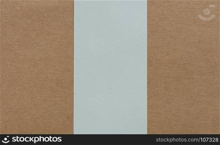 Blank white paper on brown cardboad background