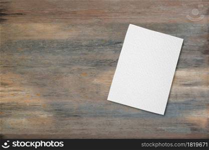 Blank white paper pad on wood desk background with copy space. Top down