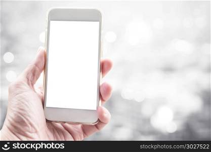 Blank white screen mobile on hand with blurred city light backgr. Blank white screen mobile on hand with blurred city light background. Business and technology background concept.
