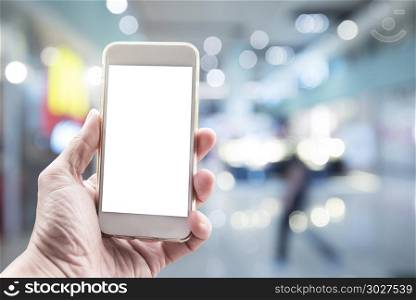 Blank white screen mobile on hand with blurred city light backgr. Blank white screen mobile on hand with blurred city light background. Business and technology background concept.