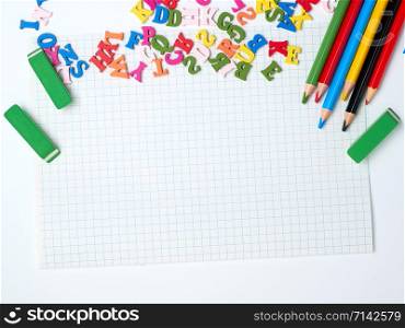 blank white sheet of squared papers and school supplies, back to school