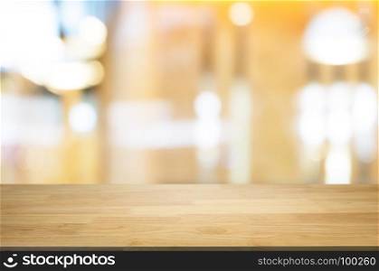 blank wooden table with blurred montage coffee shop cafe background