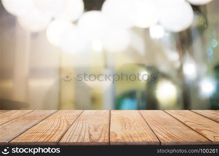 blank wooden table with blurred montage coffee shop cafe background
