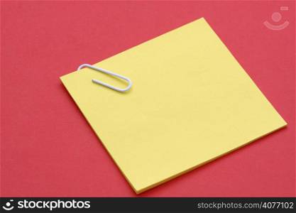 Blank yellow note on red background