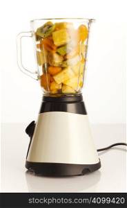 Blender filled with different fruits for smoothie