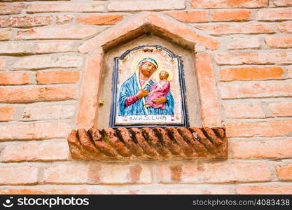 Blessed Mary votive aedicula on the wall of the houses in the medieval small village of Dozza near Bologna in Emilia Romagna, Italy