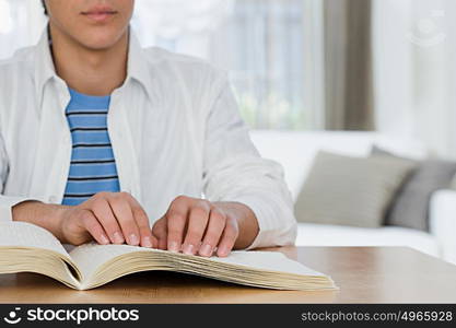 Blind boy reading a braille book