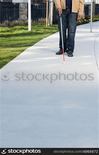Blind man walking with a stick