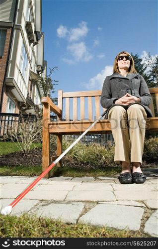 Blind woman sitting on a bench