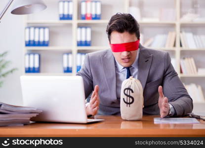 Blindfold businessman sitting at desk in office